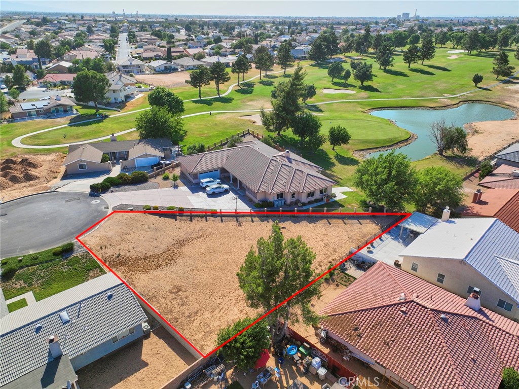 an aerial view of residential houses with outdoor space and river