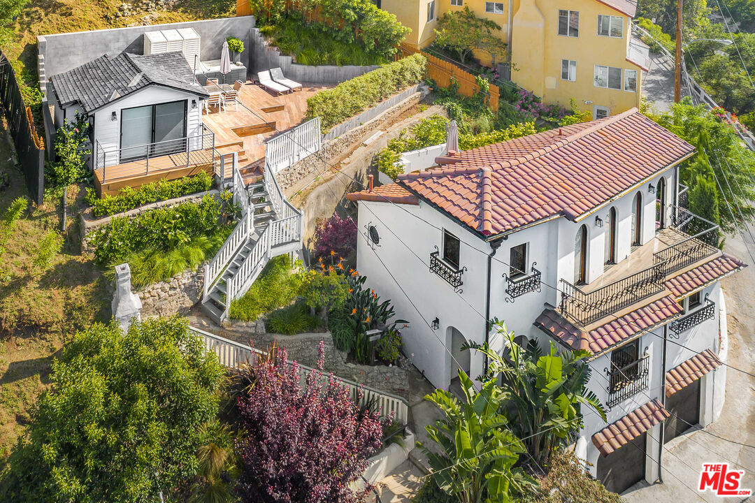 a aerial view of a house with a yard and potted plants