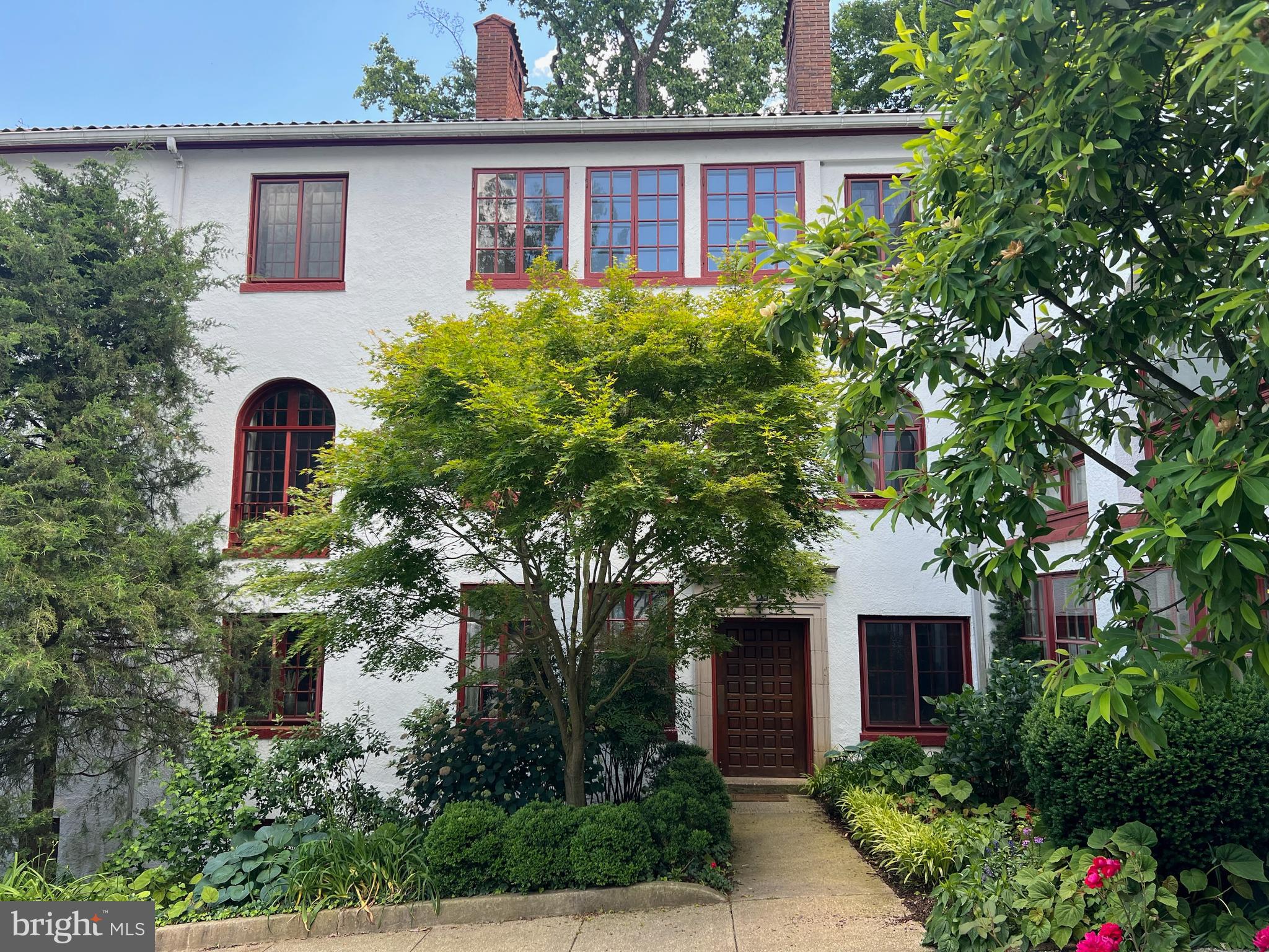 a front view of house with yard and trees around