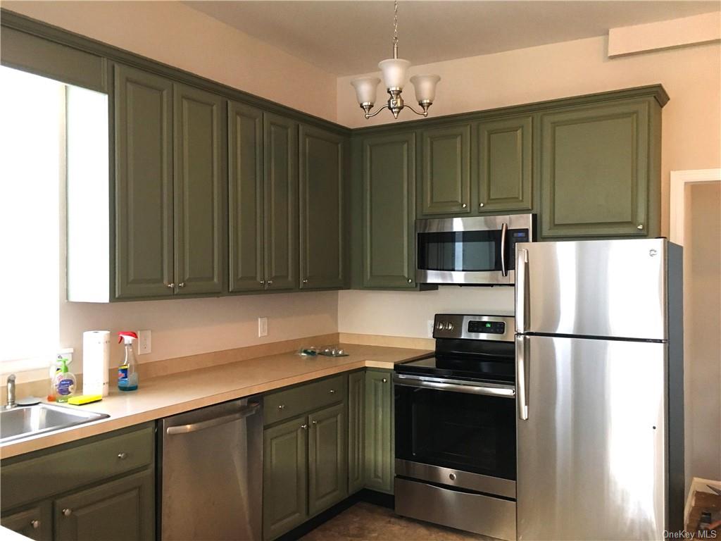 a kitchen with a sink a stove and refrigerator