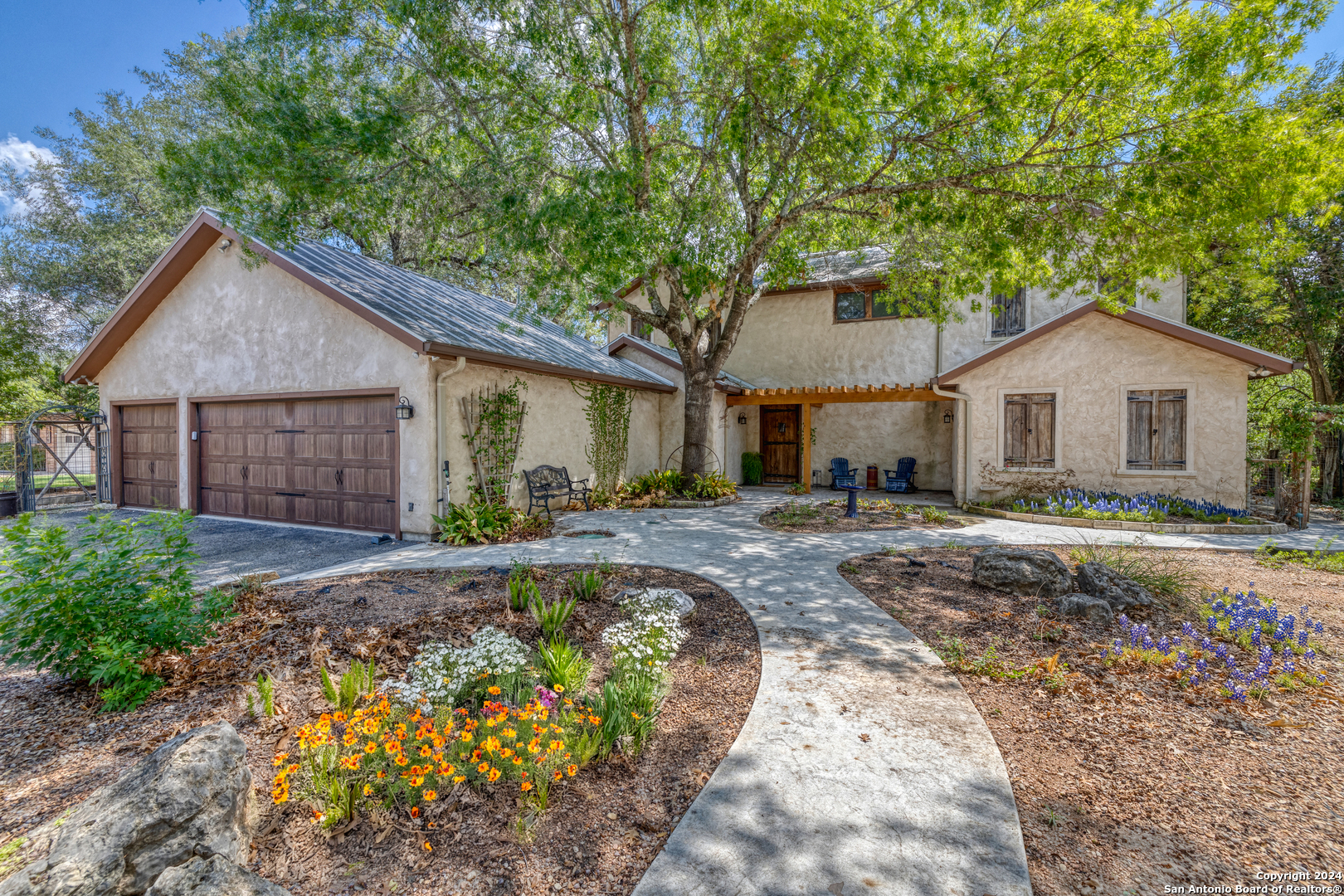 a front view of a house with a garden