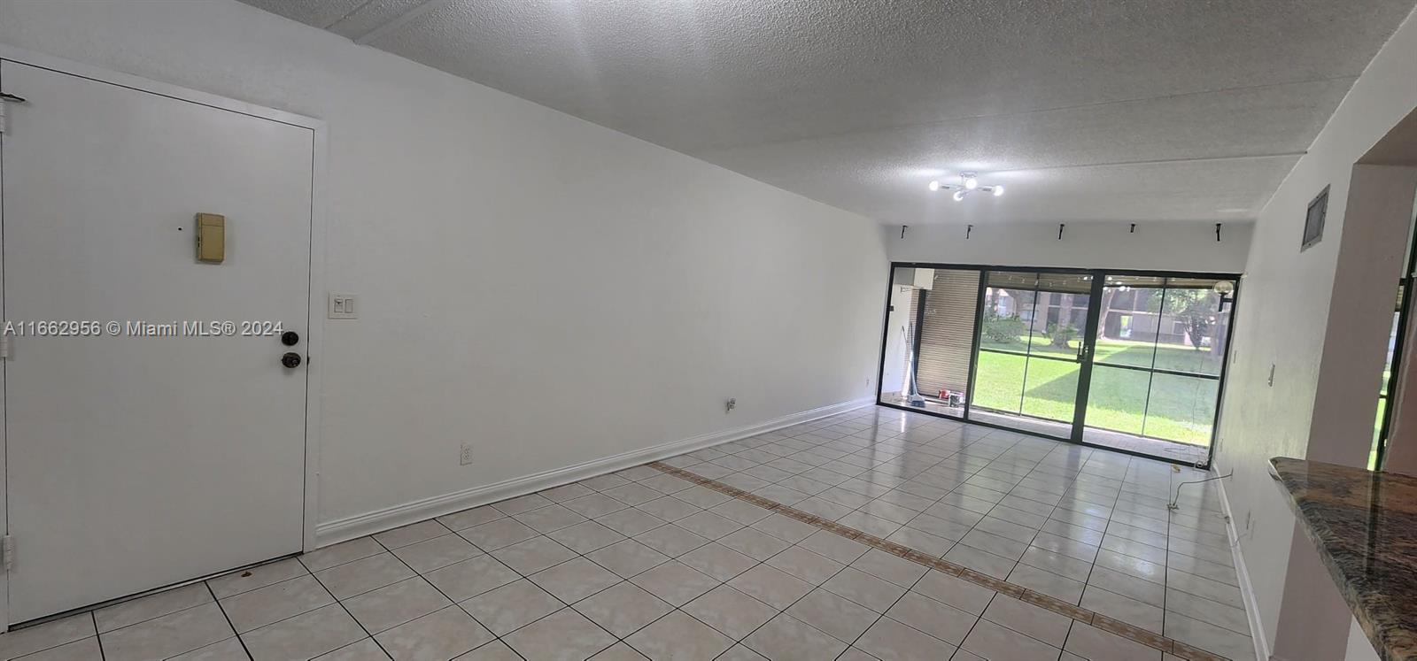 wooden floor with an empty room and window