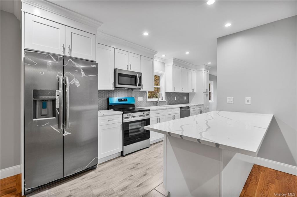 a kitchen with a refrigerator a sink and cabinets