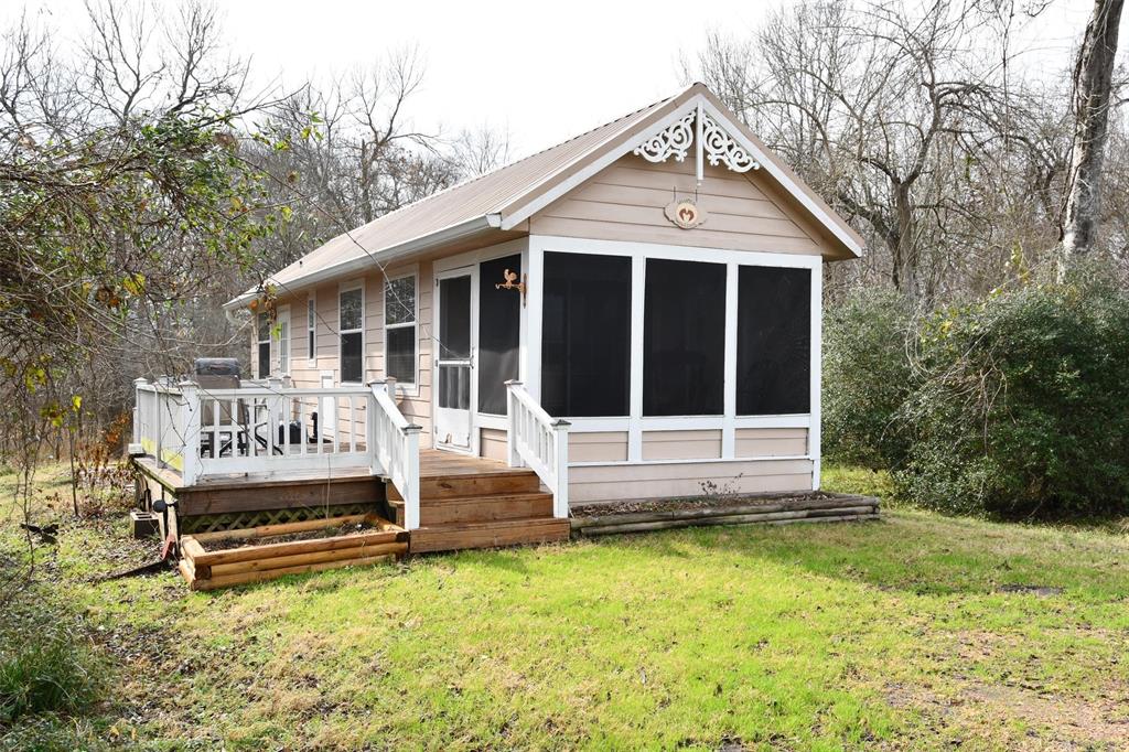 a view of a house with a yard and sitting area