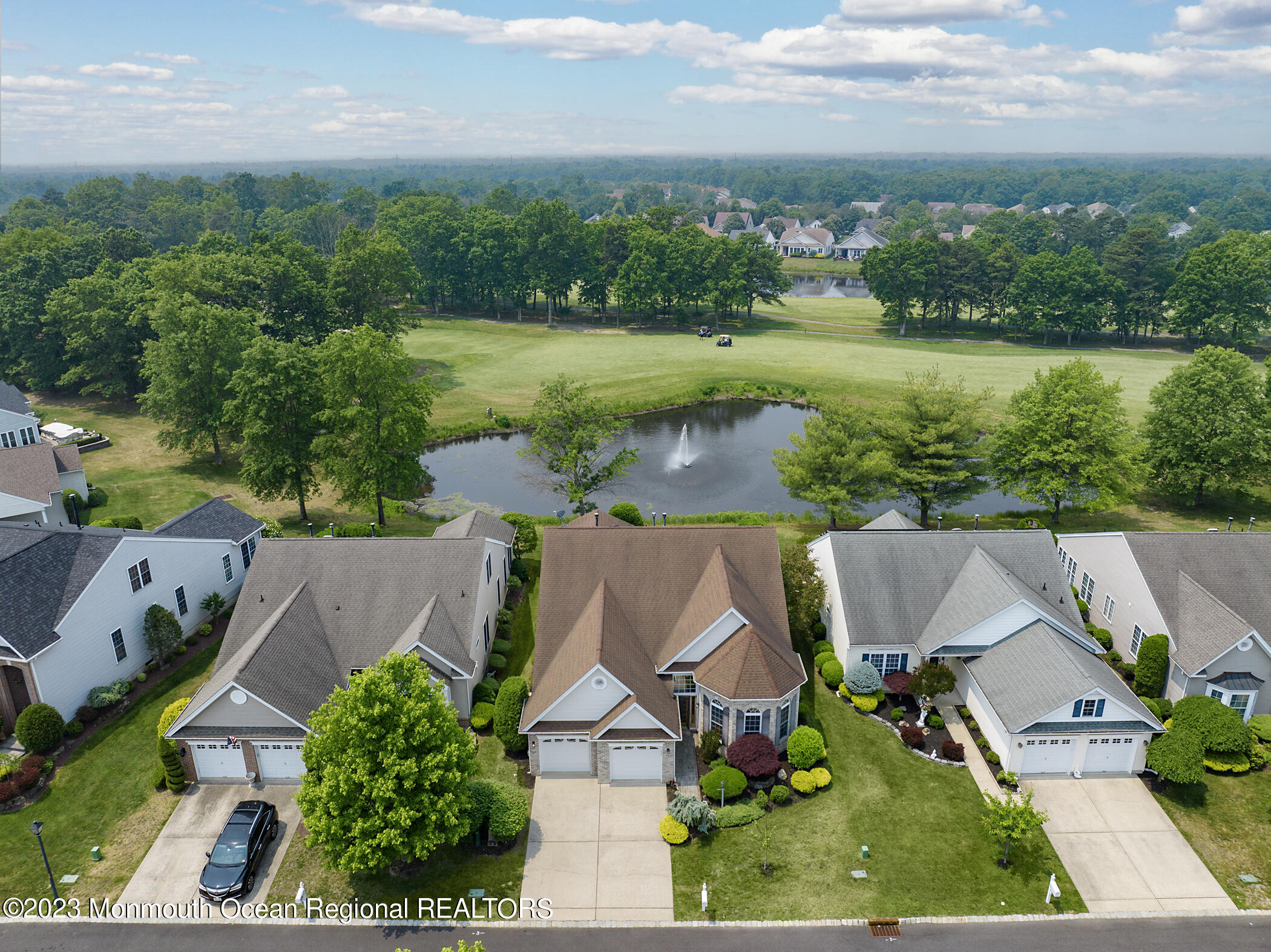 an aerial view of house with yard and lake view