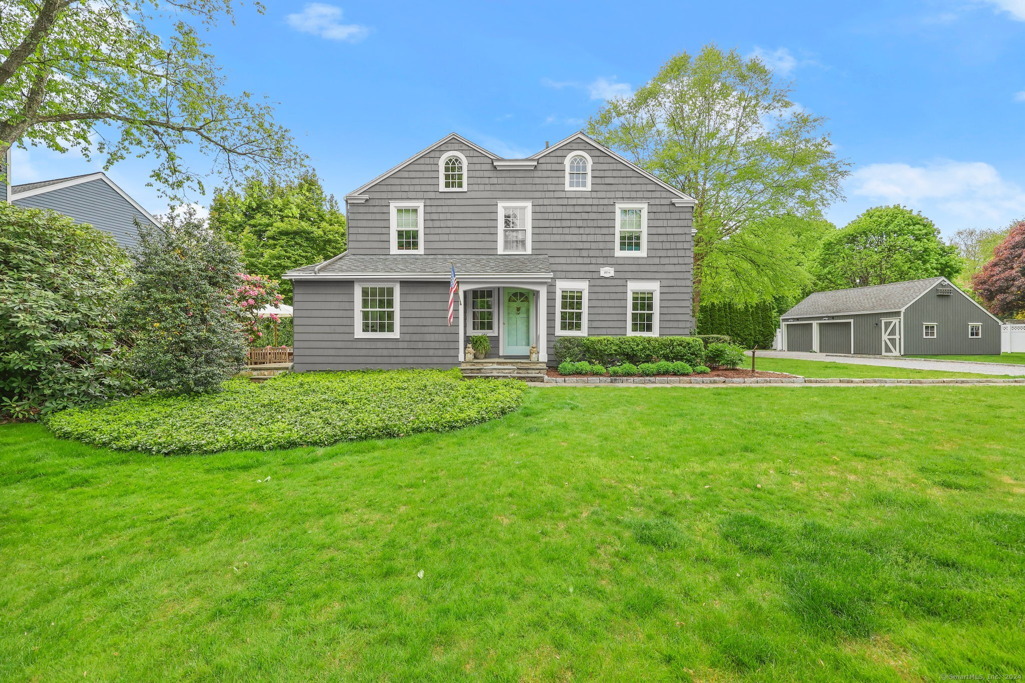 a front view of house with yard and green space