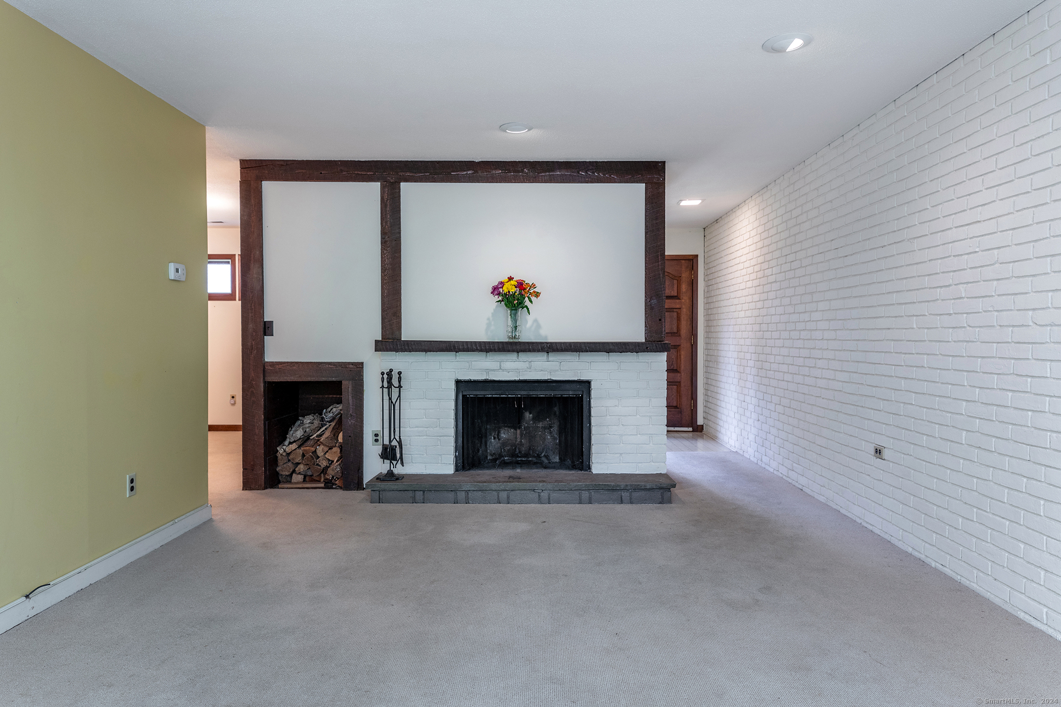 a view of an empty room with a fireplace