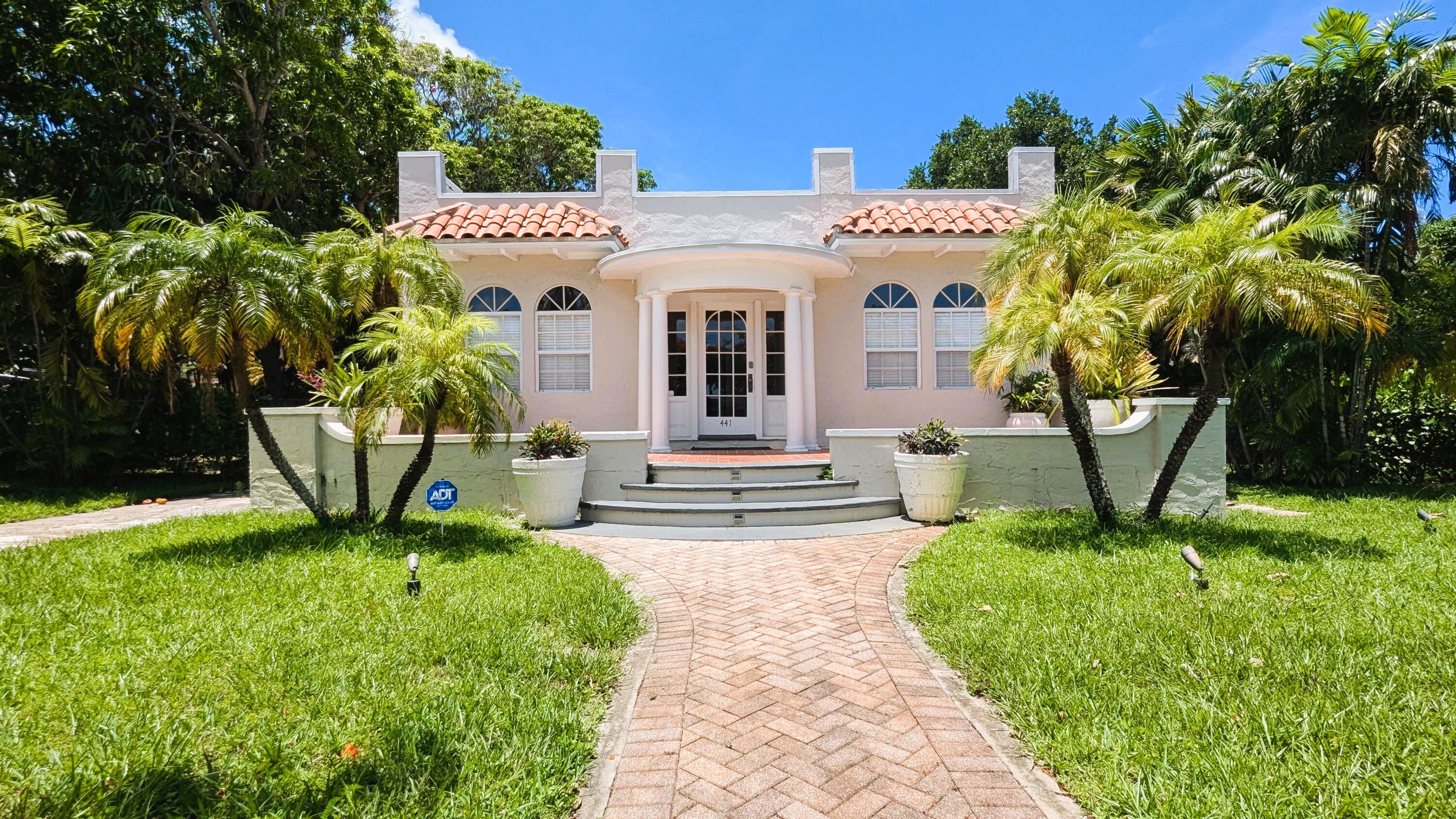 a front view of a house with garden