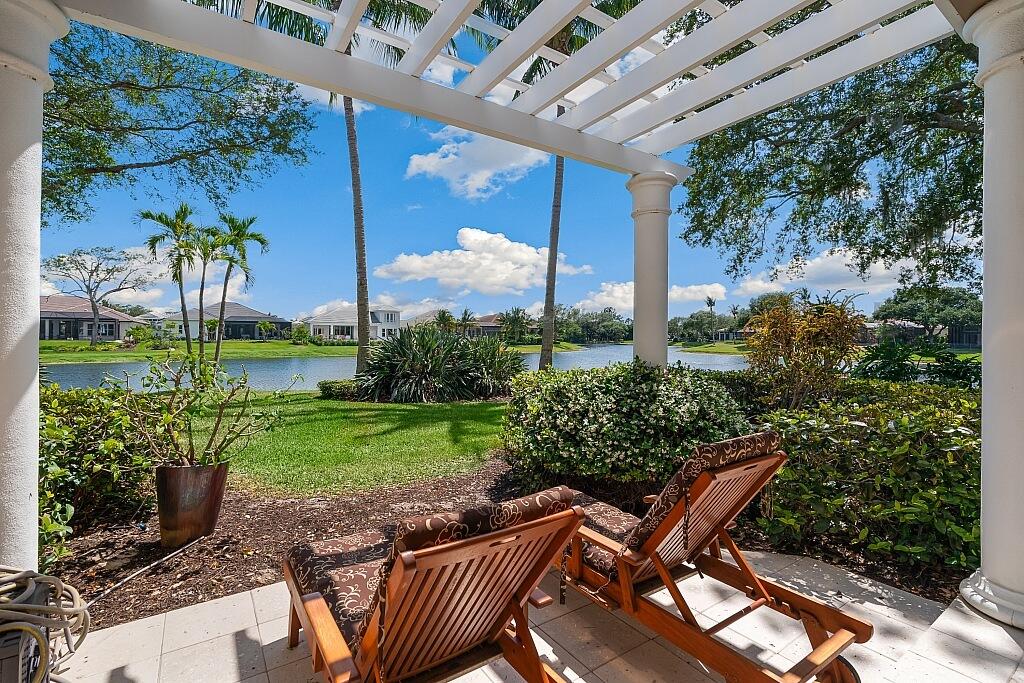 a view of a chair and table in backyard of the house