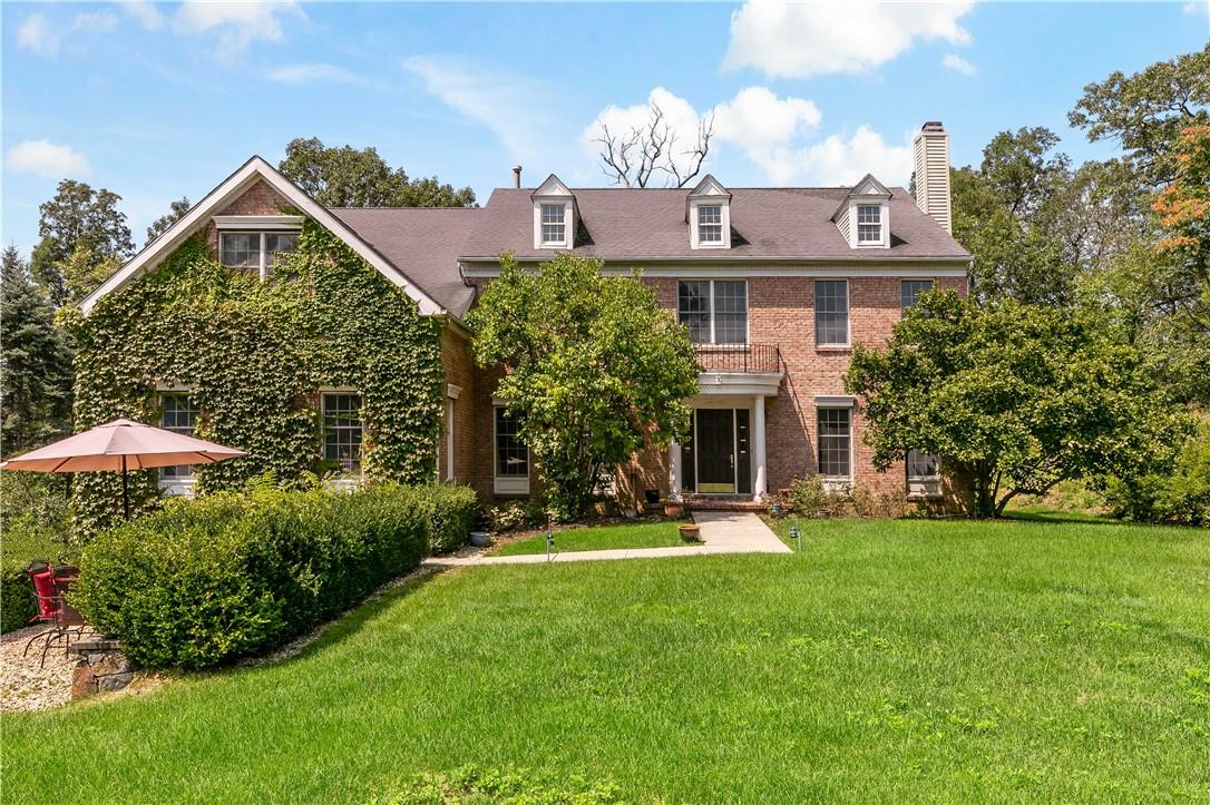 a view of a big house with a big yard and potted plants