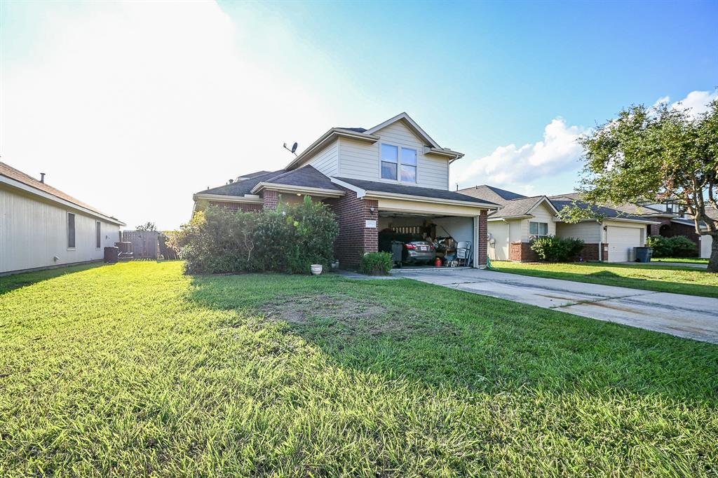 a view of house that has a big yard