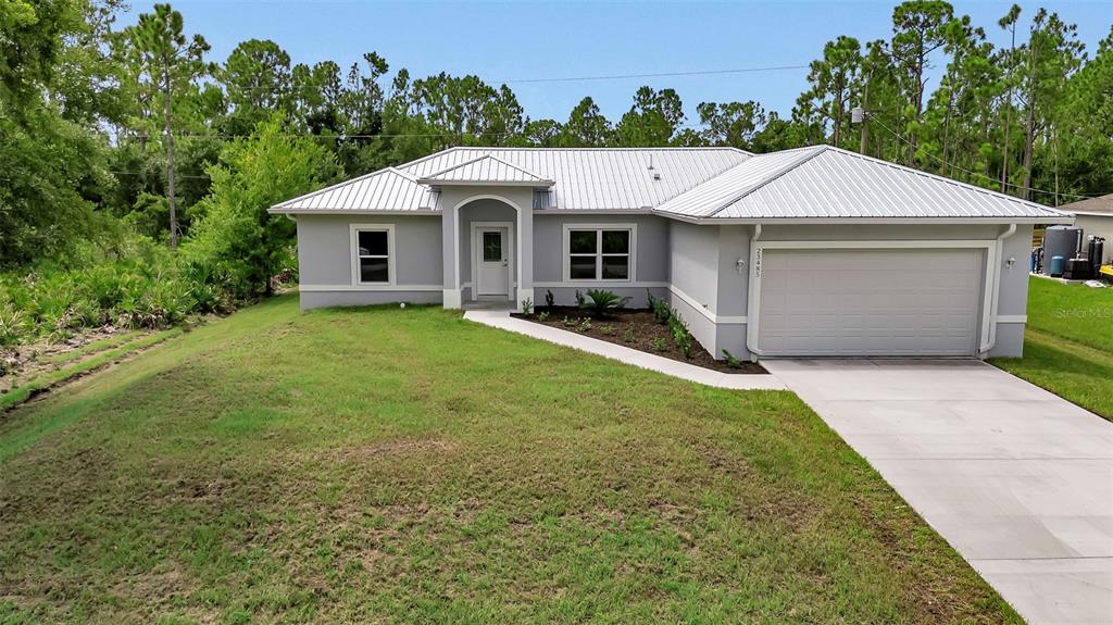 a aerial view of a house with a yard and garage