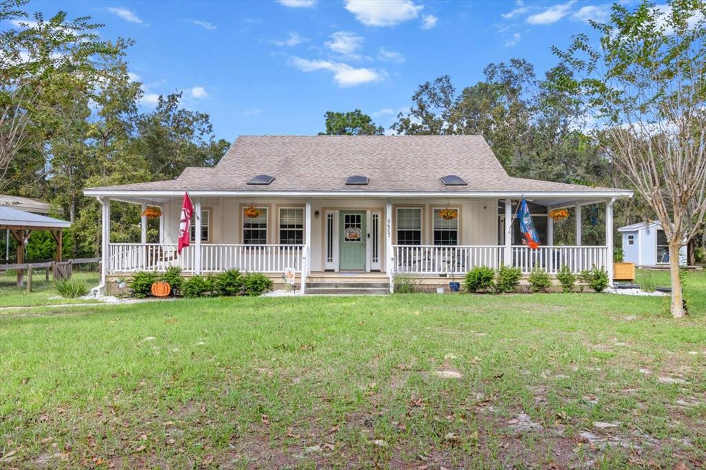 a front view of a house with a garden and porch