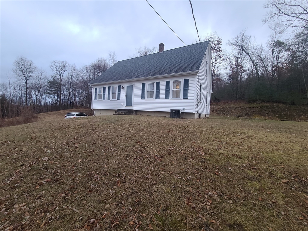 a house that has a tree in front of it