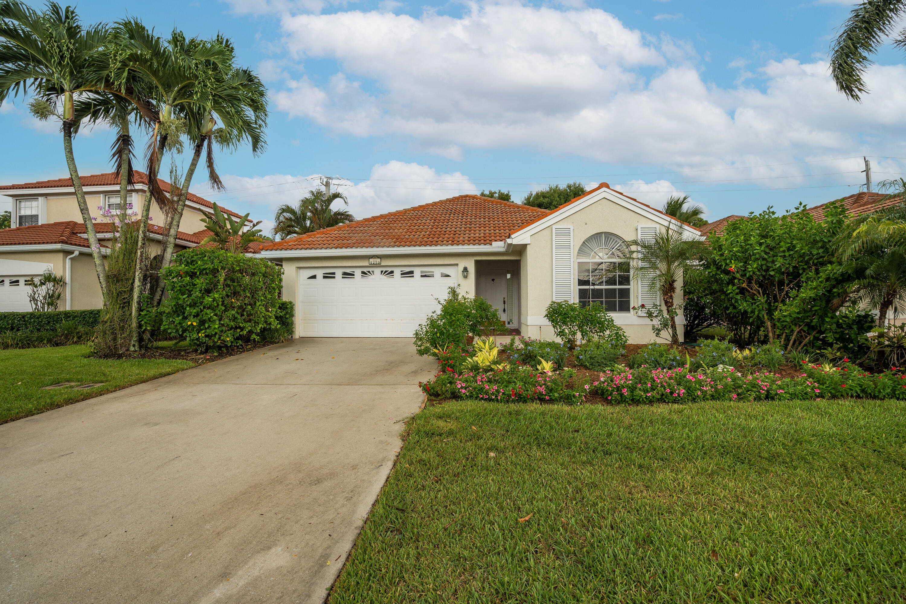 a front view of a house with a garden