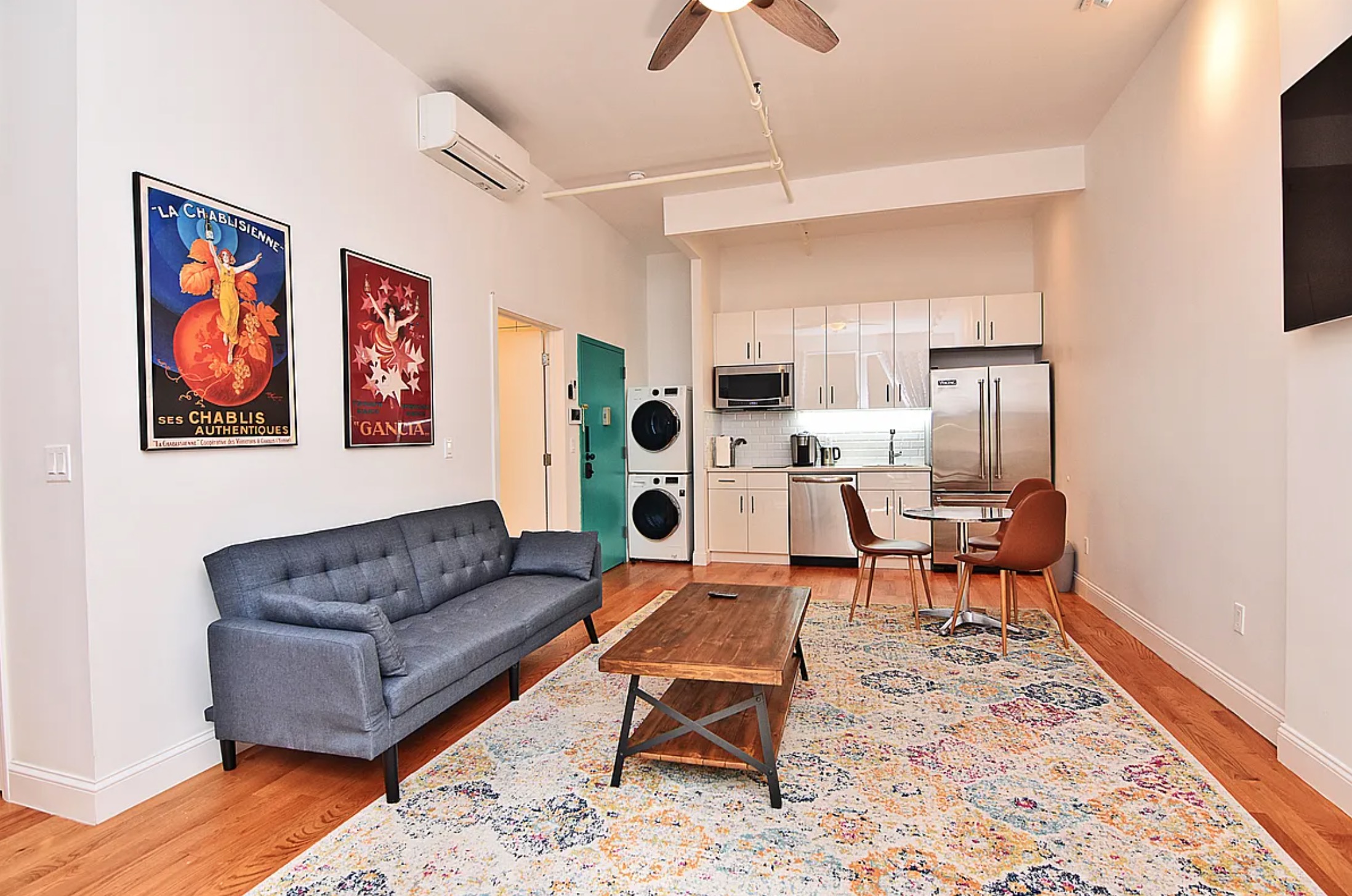 a living room with furniture a rug and a chandelier