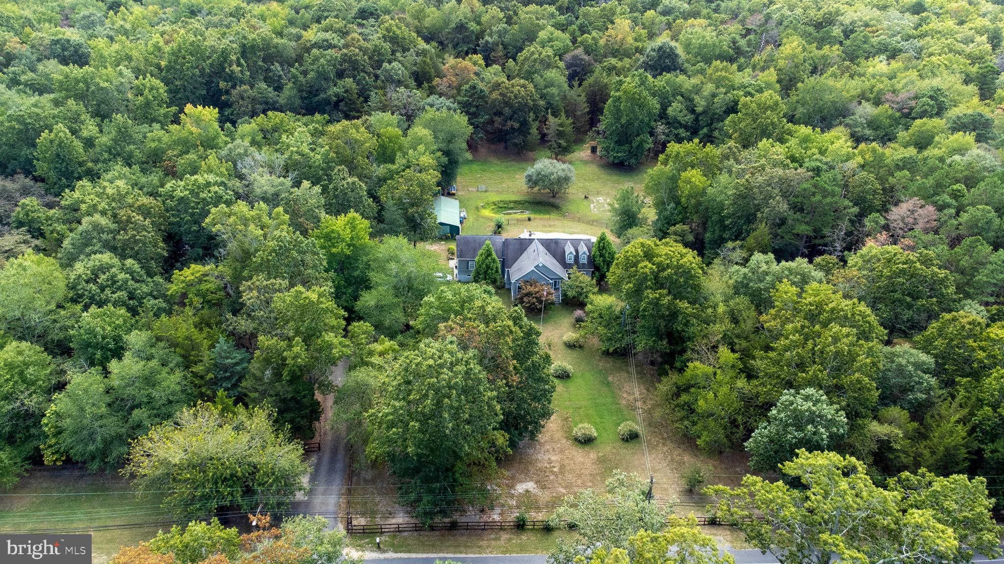 an aerial view of a house with pool outdoor seating and yard