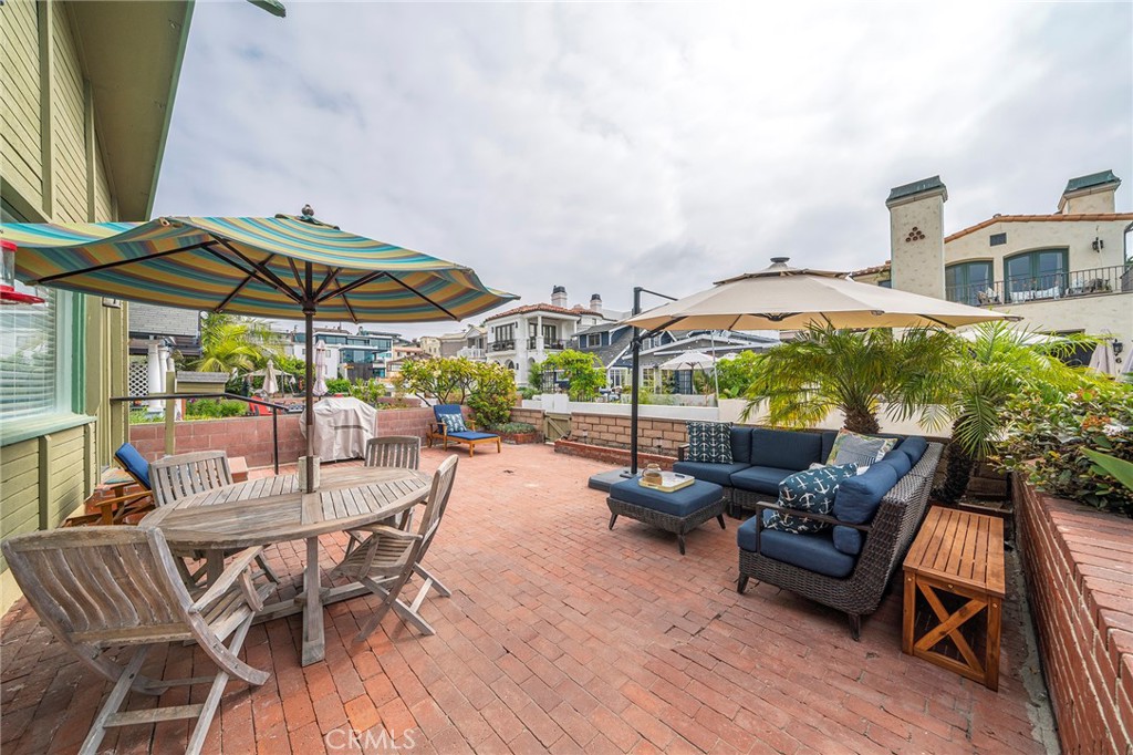 a view of a patio with a table and chairs under an umbrella