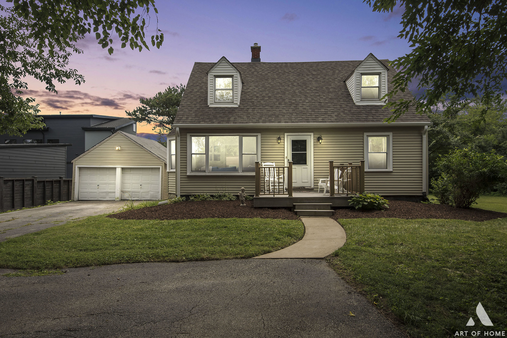 a front view of a house with a garden and yard