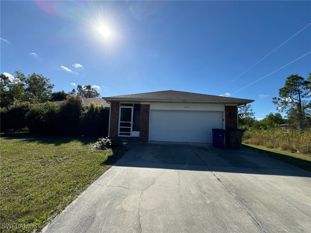 a front view of a house with a yard and a garage