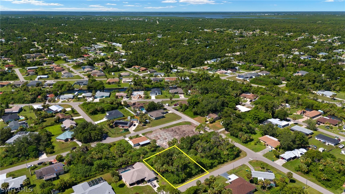 an aerial view of residential houses with outdoor space and trees