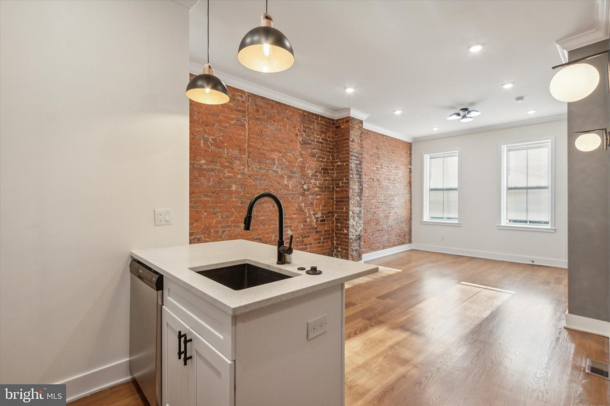 a view of kitchen with a sink and chandelier