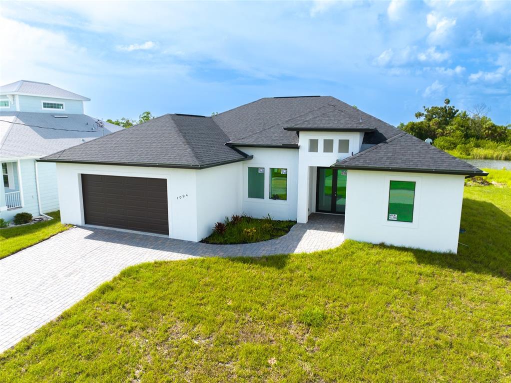 a front view of a house with yard and garage