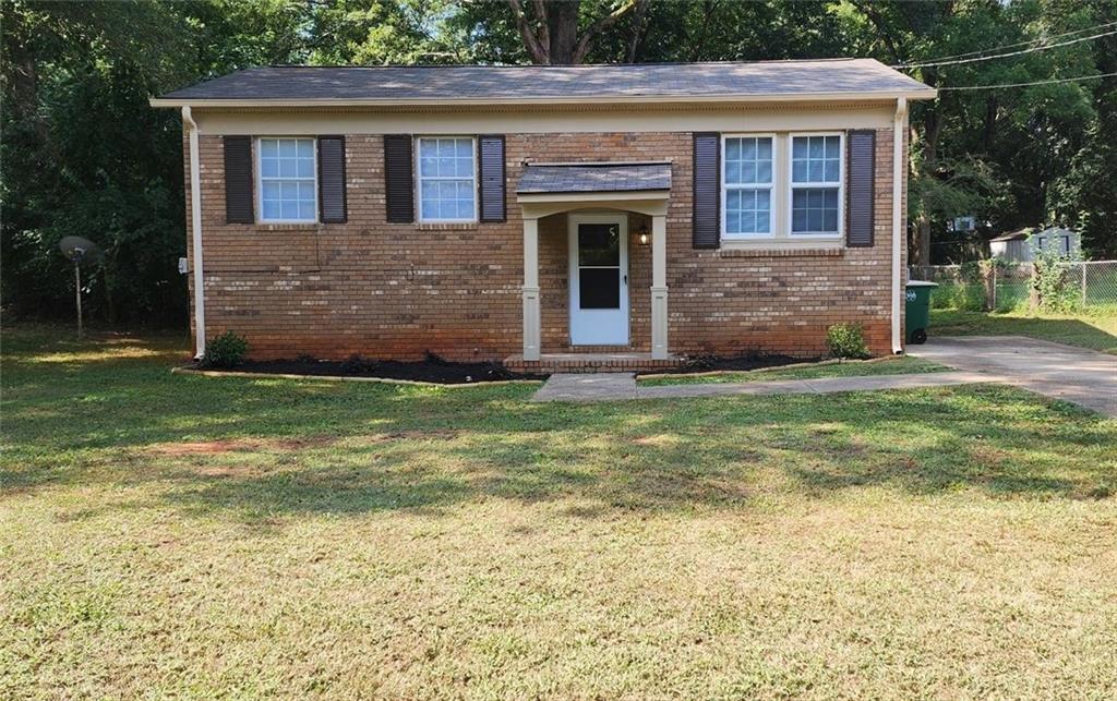 a view front of house with yard and outdoor seating