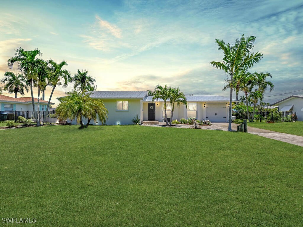 a front view of house with yard and green space