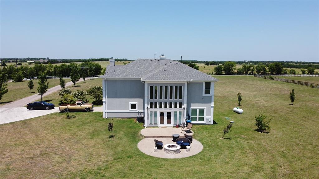 an aerial view of a house with swimming pool garden and barbeque grill