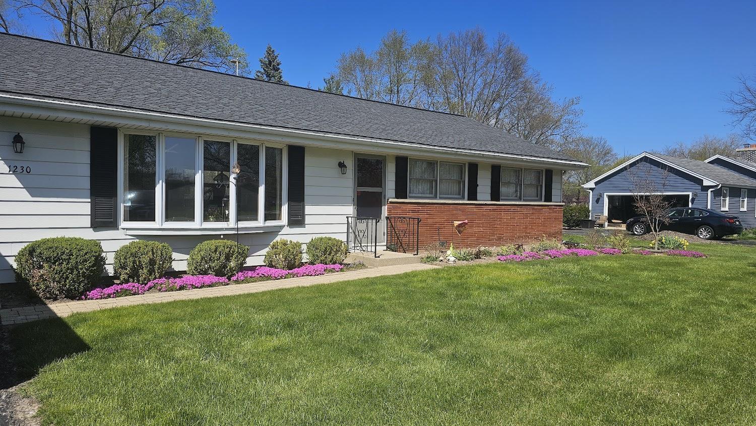 a front view of house with yard and green space