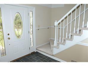 an entryway with wooden floor and door