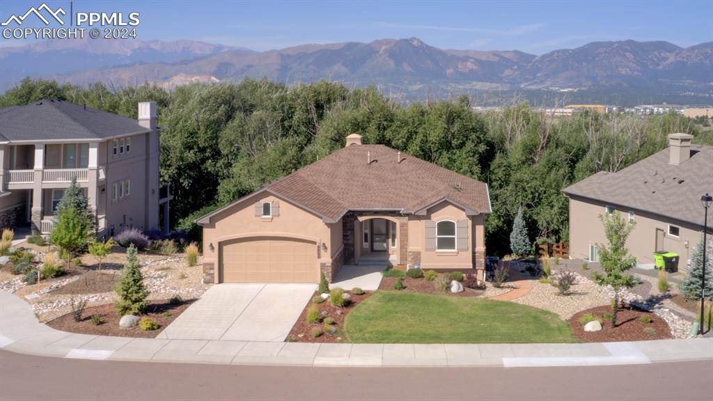 View of front facade with a mountain view and a garage