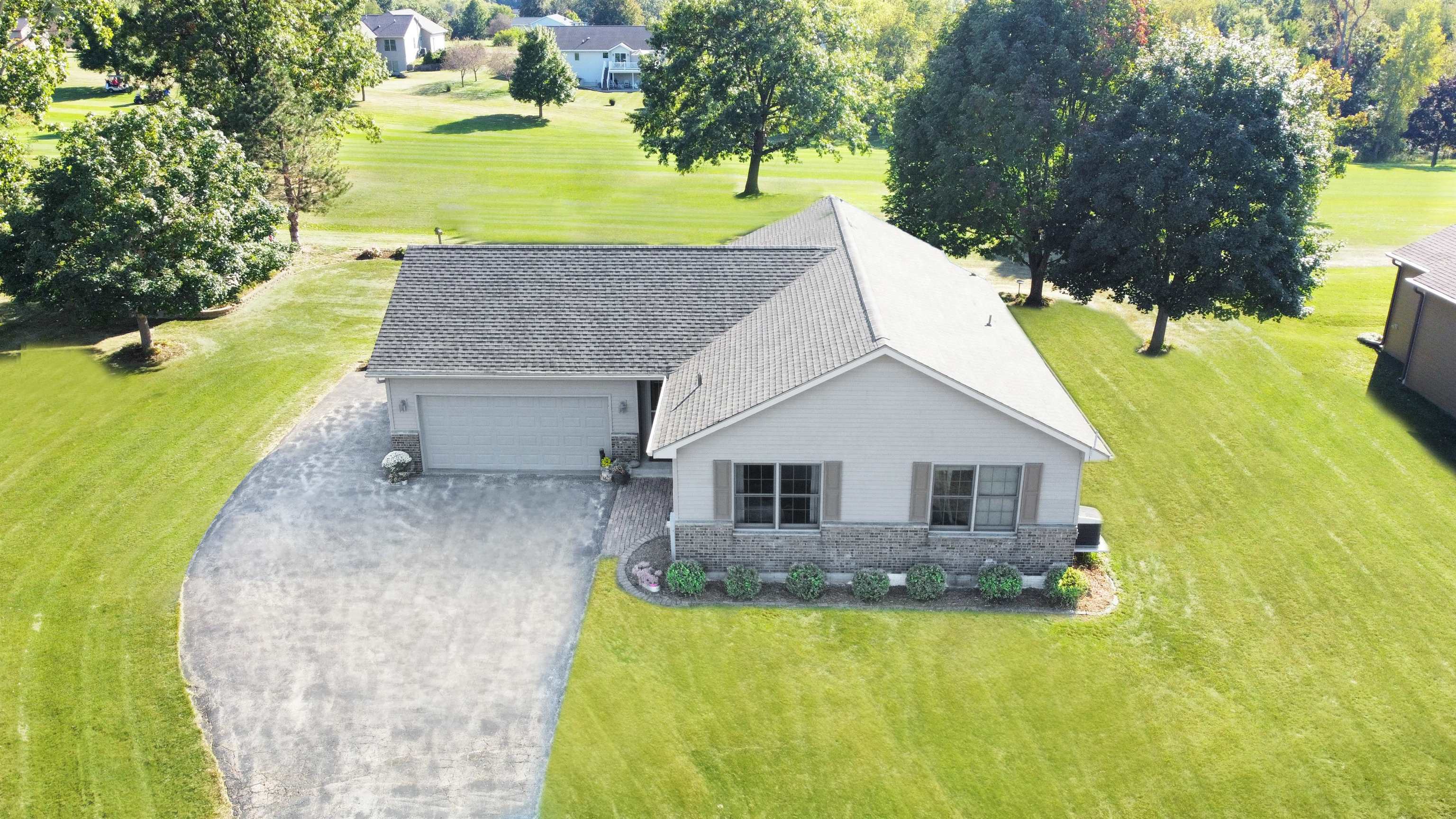 a aerial view of a house with a yard basket ball court and outdoor seating