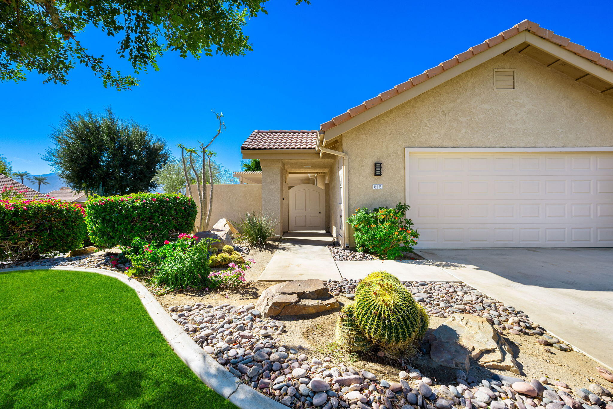 a front view of a house with garden