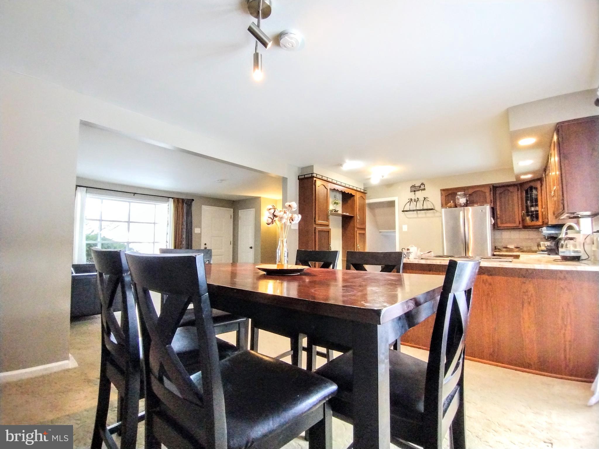 a dining room with furniture window and wooden floor