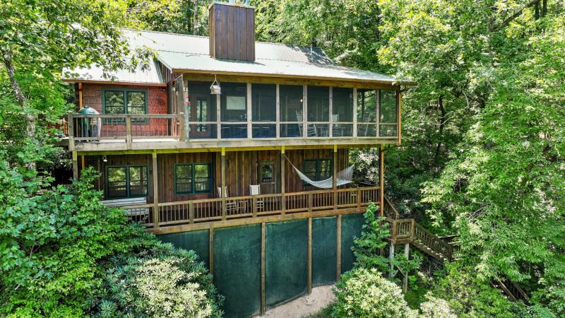 a view of a house with a yard and balcony