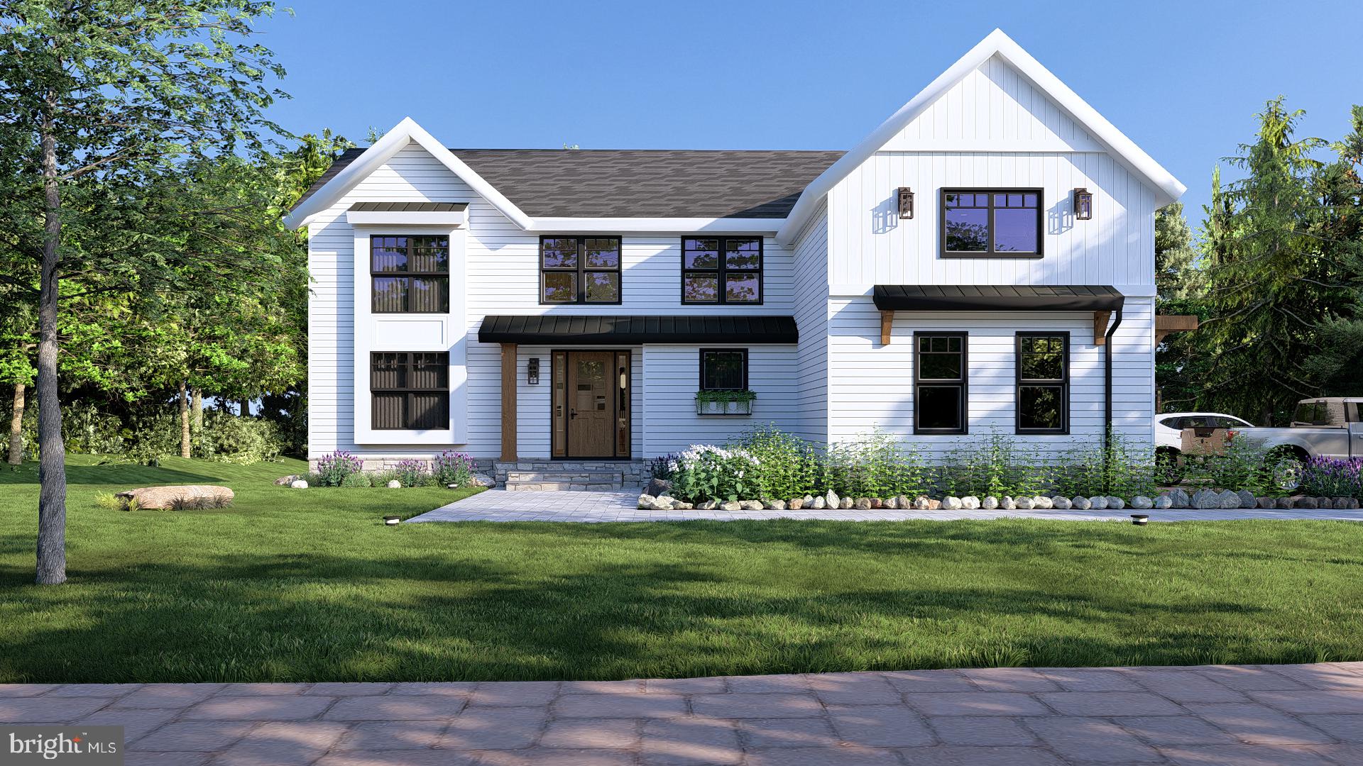 a front view of a house with a yard and plants