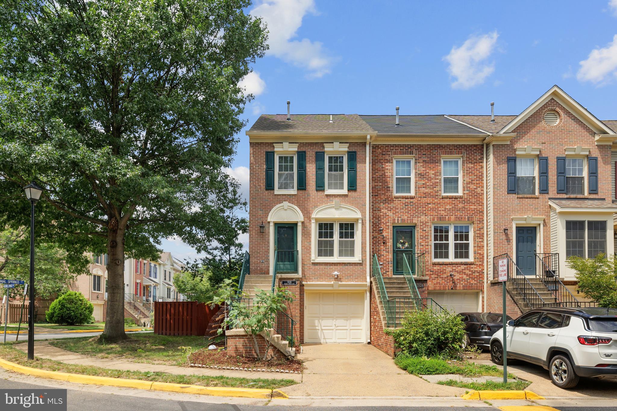 a front view of a residential houses with yard