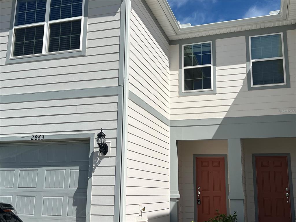 a view of a house with a door and deck