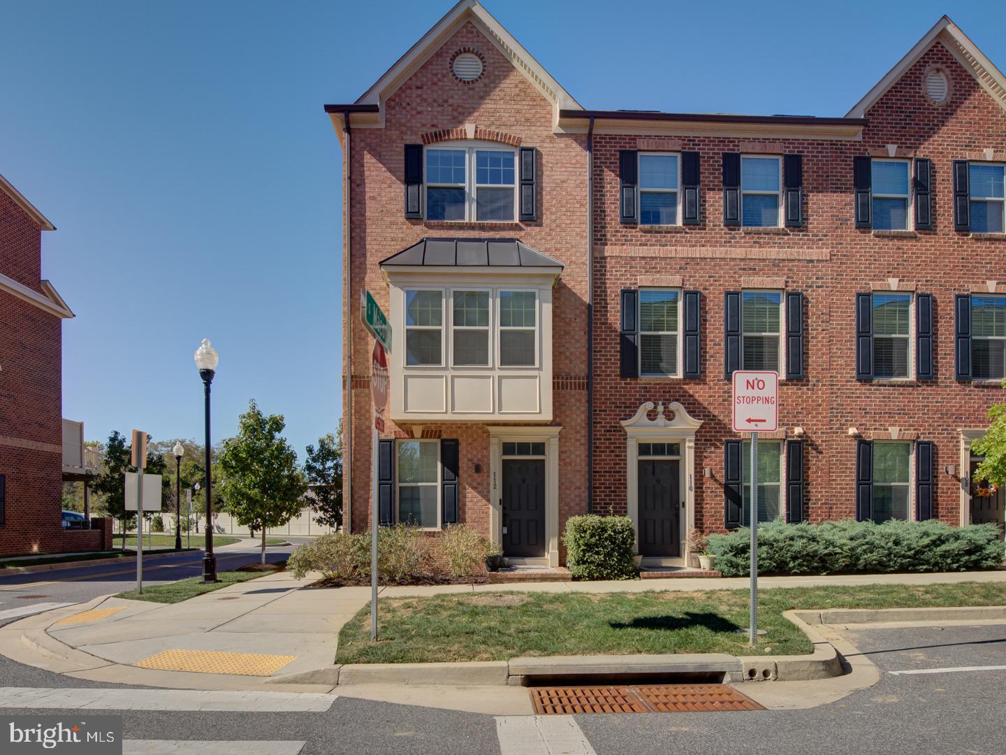 a front view of a residential apartment building with a yard