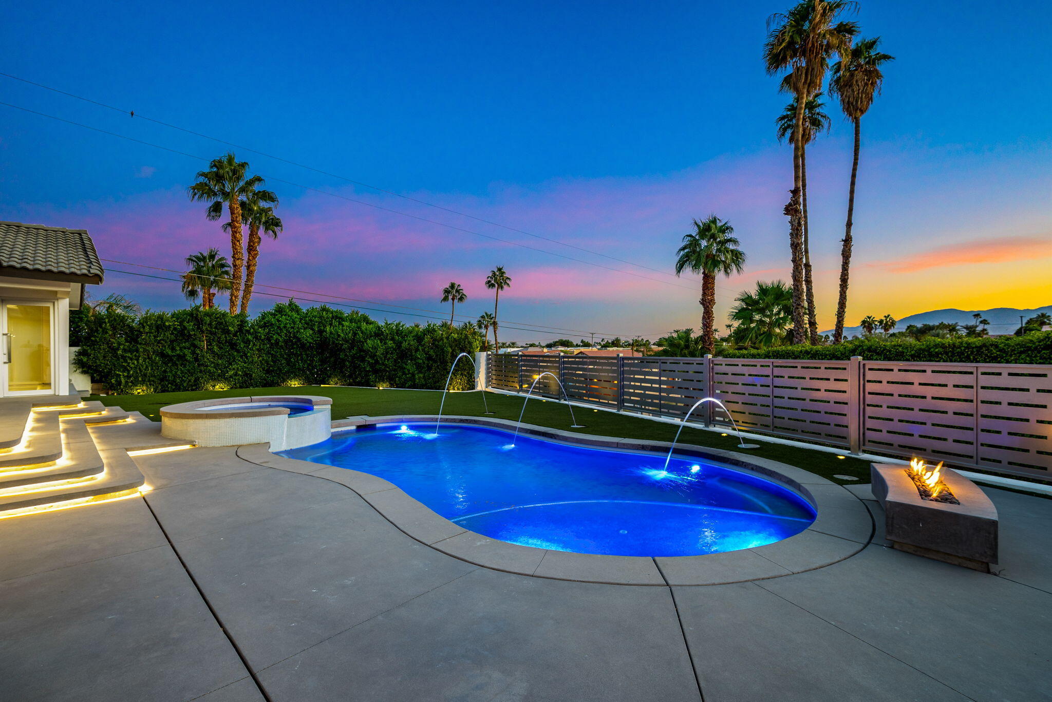 a view of a swimming pool with a table and chairs