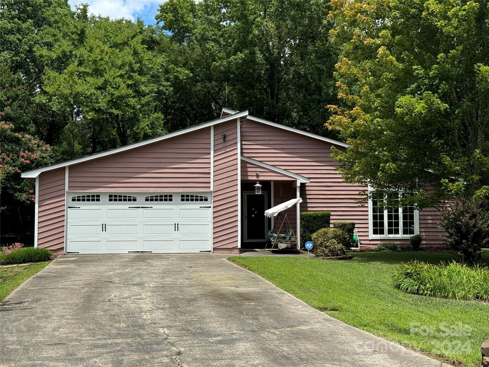 a front view of house with a garden