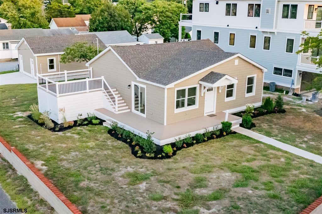 an aerial view of residential houses with yard