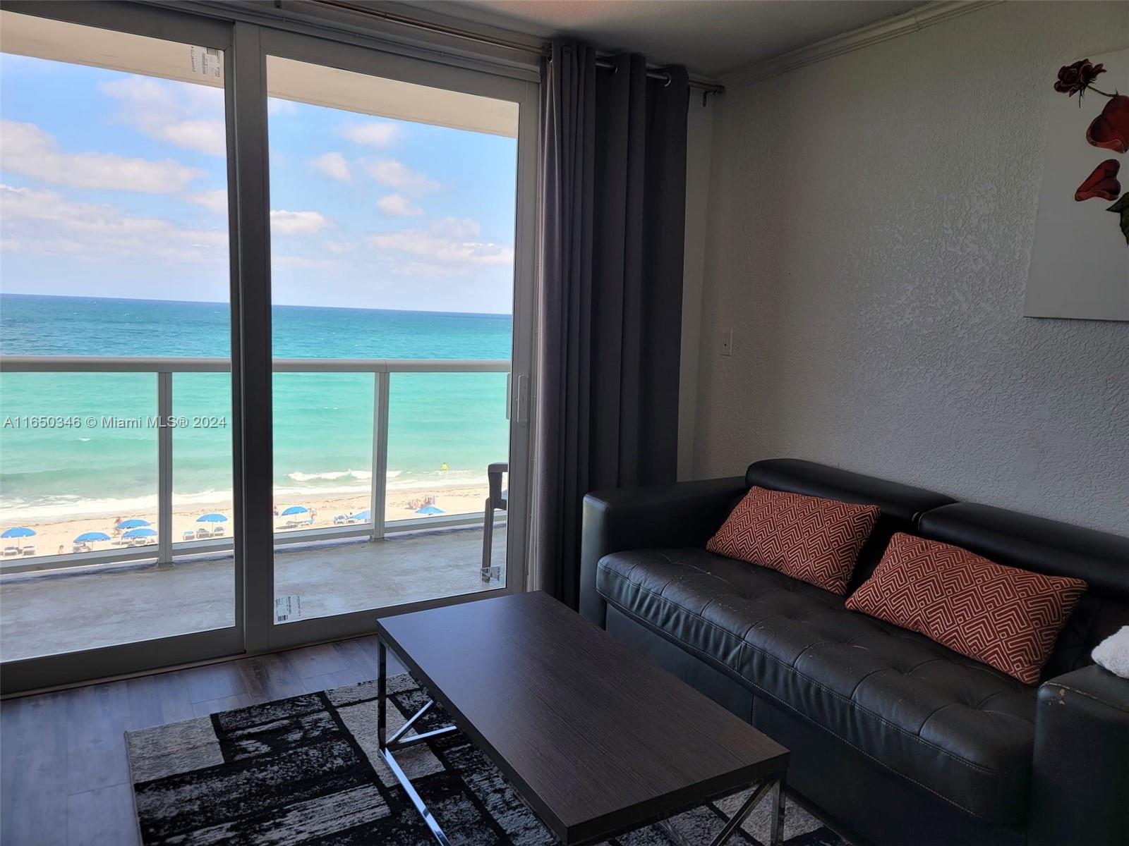 a living room with a couch and a large window