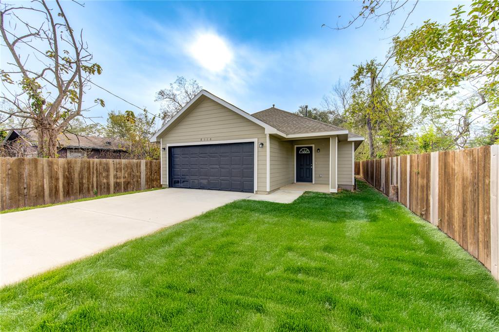 a front view of a house with yard and green space