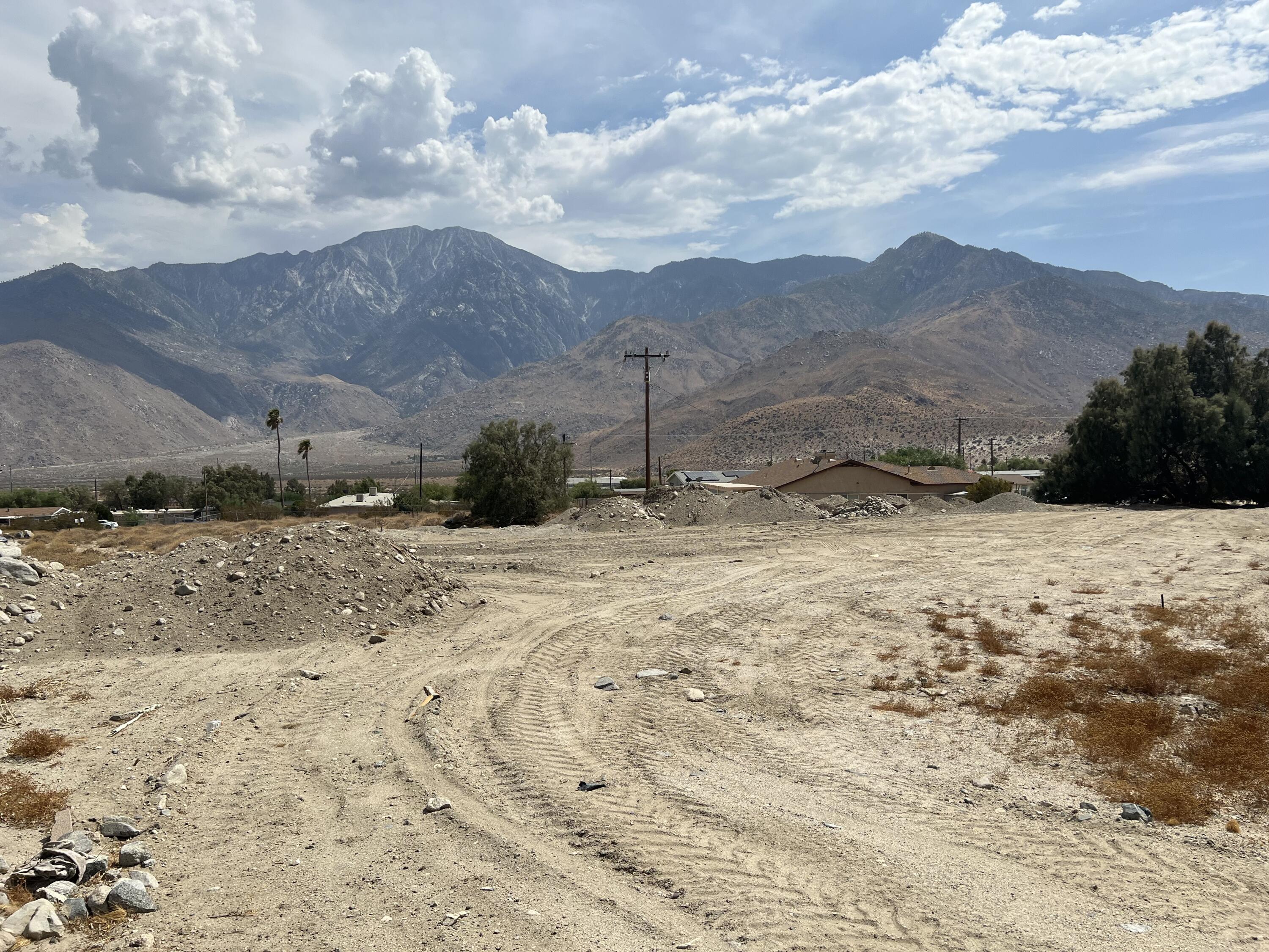 a view of a dry yard with mountains