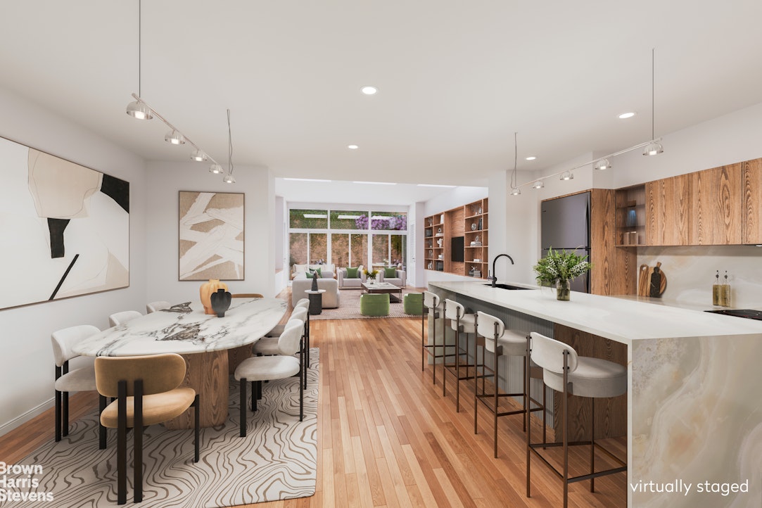 a large kitchen with kitchen island a dining table and chairs