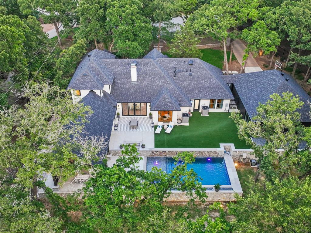 an aerial view of house with yard swimming pool and outdoor seating