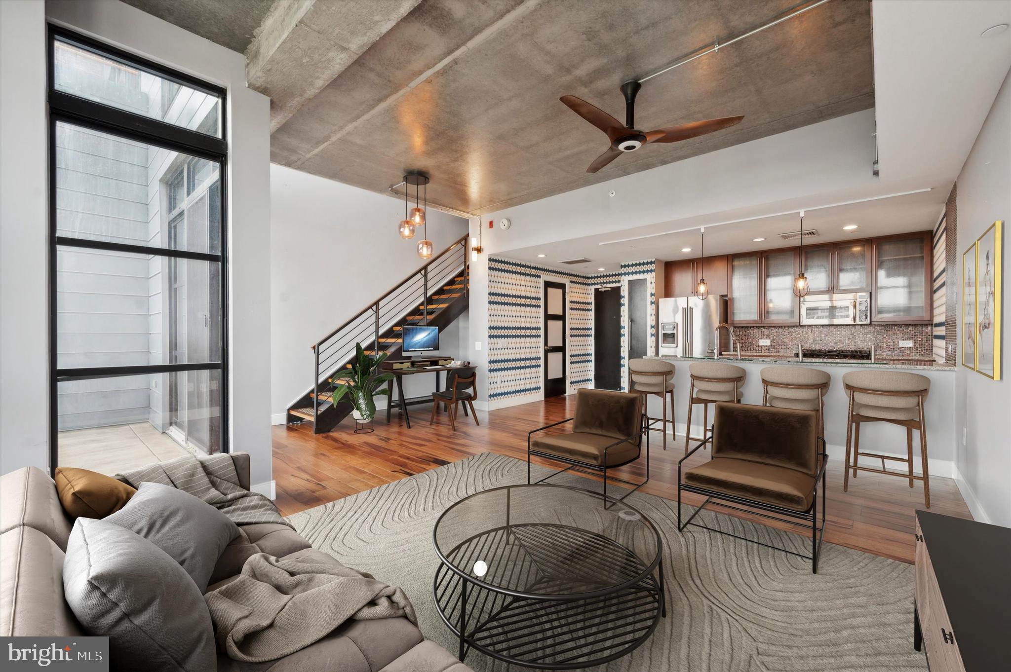 a living room with furniture and wooden floor